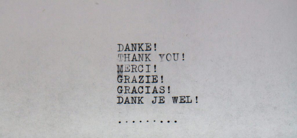a typewriter written sequence of words with various languages - all reading thank you.